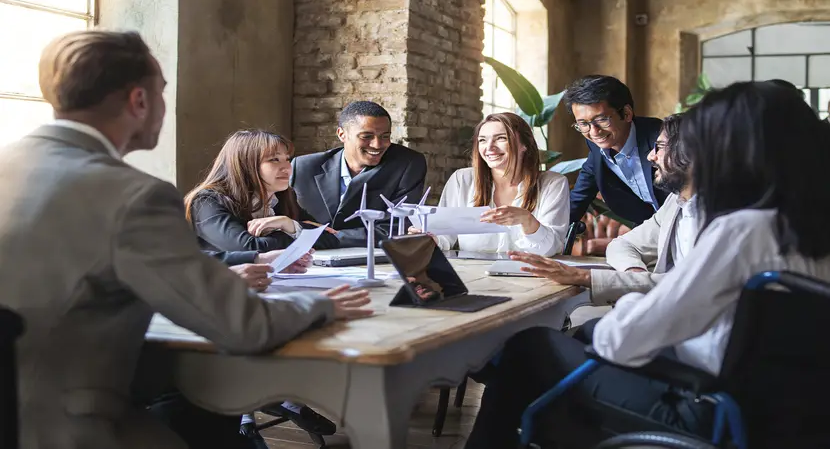 team of coworkers experiencing staff efficiency while talking around a table